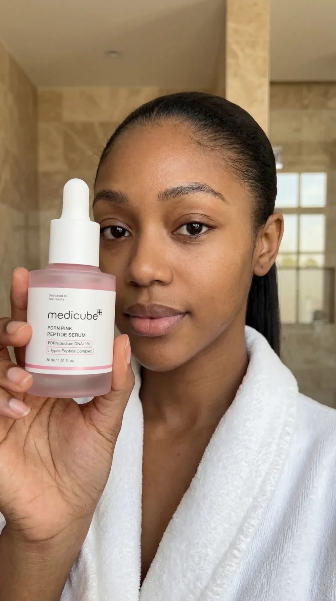 AI-generated Medicube skincare portrait holding a pink serum bottle